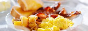 breakfast with eggs bacon and hashbrowns panorama